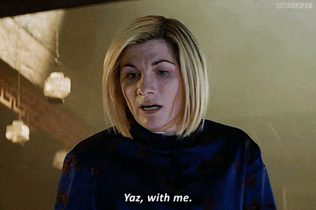 a woman in a blue sweater is saying yaz with me