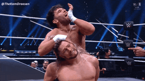 two wrestlers in a wrestling ring with the hashtag thekamdreesen on the screen
