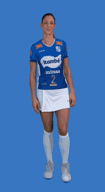 a woman wearing a blue and white itambé mina 2 jersey