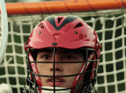 a lacrosse player wearing a red helmet that says cabe