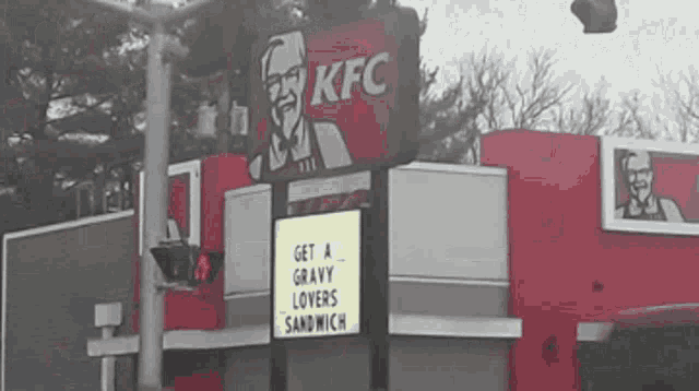 a sign outside of a kfc restaurant says get a gravy lovers sandwich
