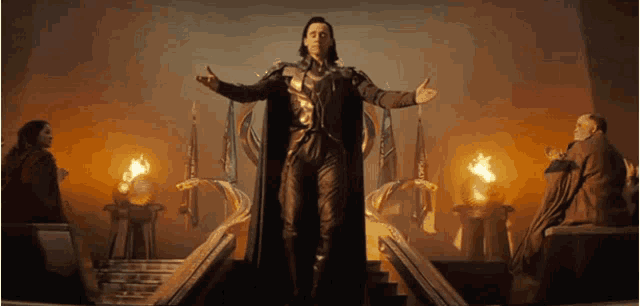 a man is standing on a throne with his arms outstretched in front of a group of people .