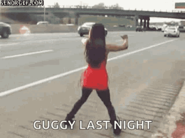 a woman is dancing on the side of the road .