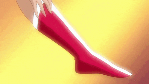 a woman is putting on a pair of red stockings on her leg .