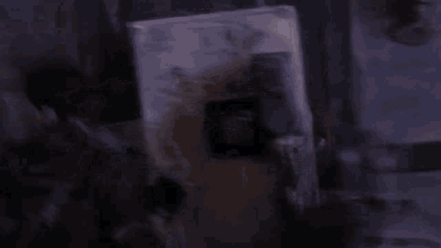 a group of people are gathered in a dark room with smoke coming out of the wall