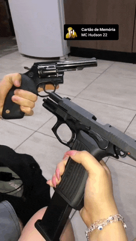 a person holding a gun with a cardo de memoria mc hudson 22 written on it