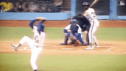 a baseball player wearing number 24 is about to swing at a pitch