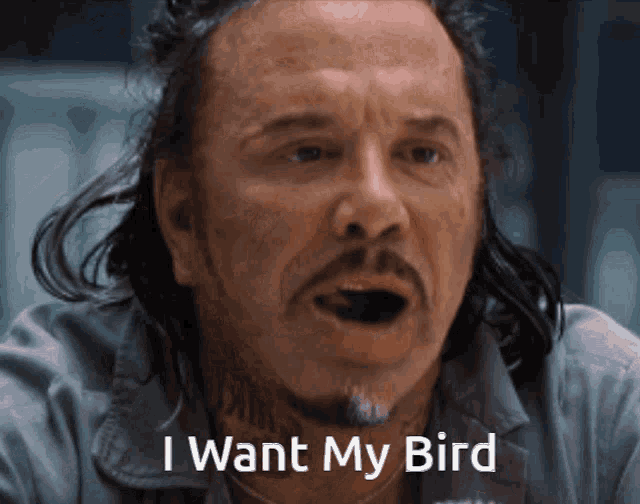 a man with a beard and long hair says i want my bird