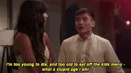 a man and a woman are standing next to each other in a room .
