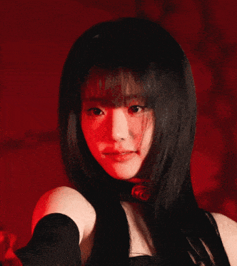 a woman with black hair and a choker with a red rose on it