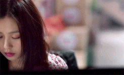 a close up of a woman 's face with a blurry background