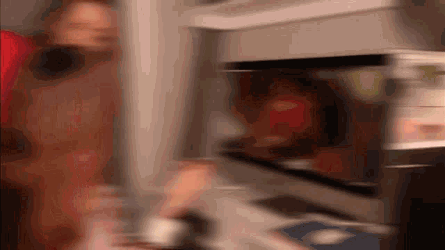 a blurry picture of a person taking a picture of another person in a kitchen
