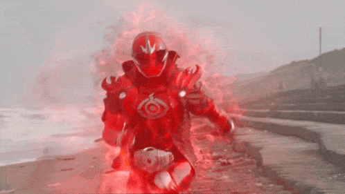 a man in a red costume with a red eye on his chest
