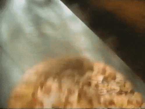 a blurred image of a pile of food with a green background