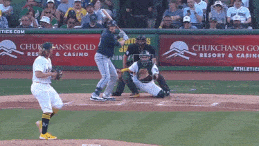 a baseball game is being played in front of a chukchansi gold resort and casino sign