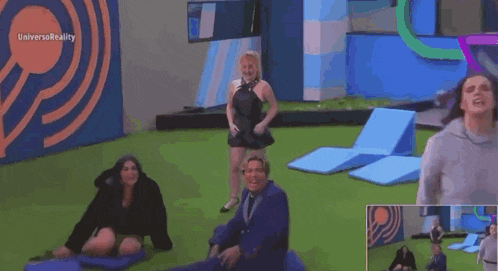 a woman is screaming in a room with a fire pit in the middle .