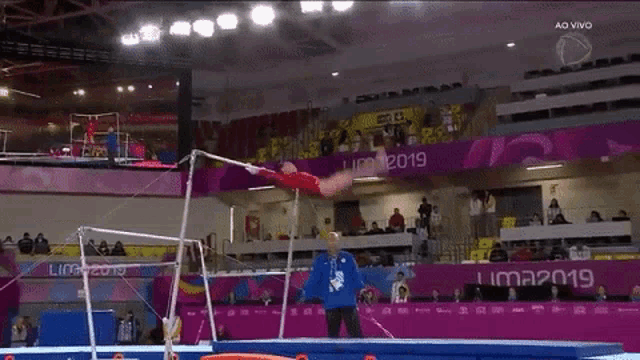 a gymnast is doing a trick on the uneven bars at the lima 2019 olympics
