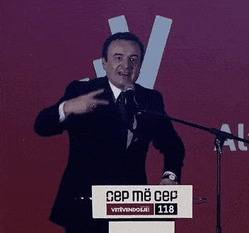 a man stands behind a podium that says cep me cep on it
