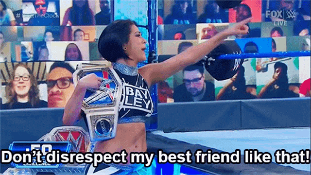 a woman in a wrestling ring is holding a championship belt and saying do n't disrespect my best friend like that