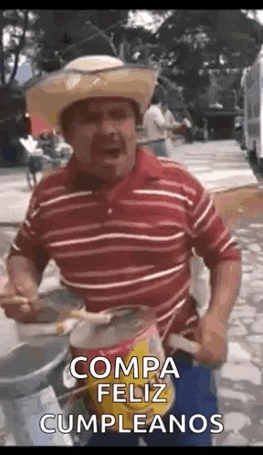 a man in a cowboy hat is playing a drum in spanish .