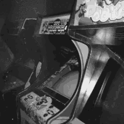 a black and white photo of an arcade game that says ' snoopy ' on the top