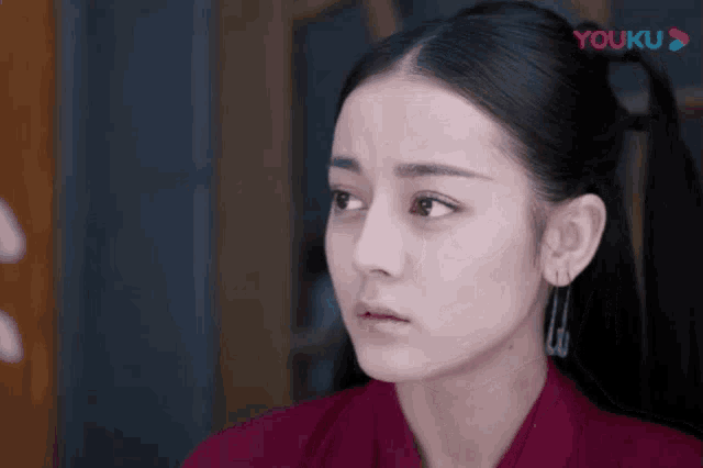 a close up of a woman 's face with the word youku on the bottom