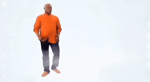 a man in an orange shirt and blue jeans is standing on a white background .
