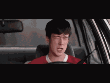 a man yawning while driving a car with his mouth open