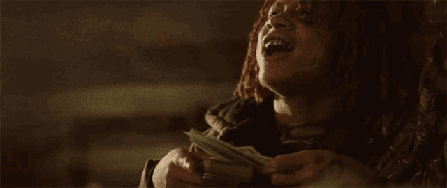a person is holding a stack of money and a ticket that says ' tickets ' on it