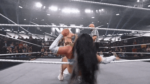 a wrestler is being lifted in the air by another wrestler