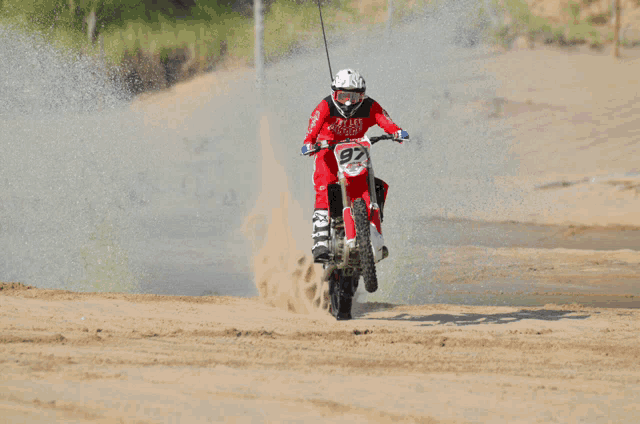 a man riding a dirt bike with the number 92 on it