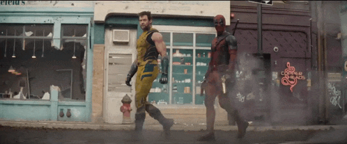 wolverine and deadpool walk down a street in front of copper palace