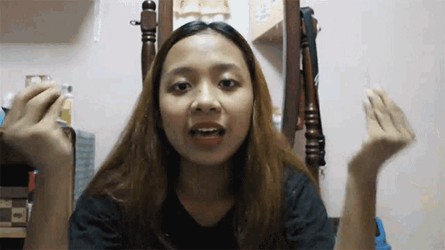 a woman with long hair is sitting in front of a mirror