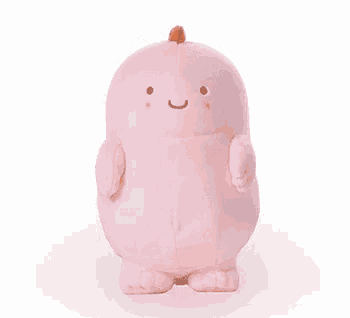 a pink stuffed dinosaur is sitting on a white background .