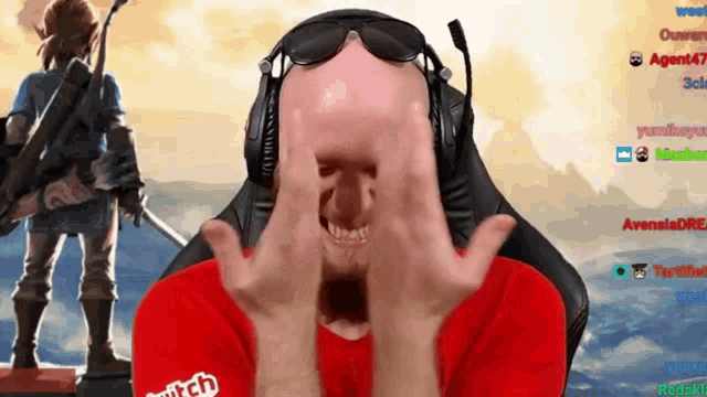 a man wearing headphones and sunglasses is covering his face