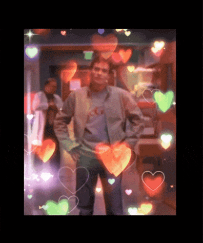 a man in a nike shirt is surrounded by heart shaped lights