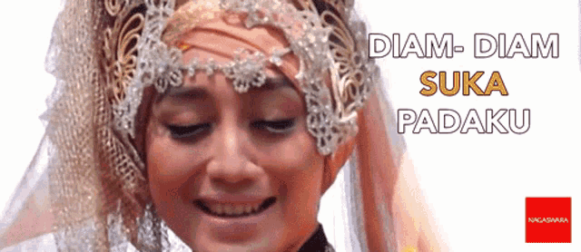 a woman wearing a headpiece with the words diam-diam suka padaku
