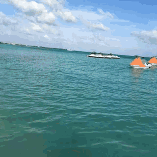 a couple of jet skis are floating on top of a body of water