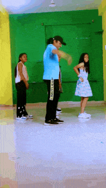 a group of young girls are dancing with a man wearing black pants that say limitless