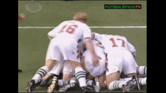 a group of soccer players huddled together with the number 17 on the back