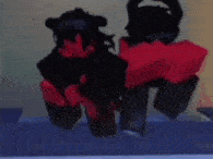 a blurry picture of two cartoon characters sitting next to each other
