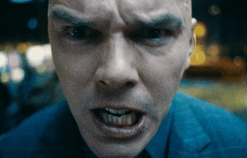a close up of a man 's face with a very angry look on his face