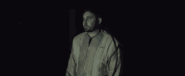a man wearing a jacket with the number 01 on the front