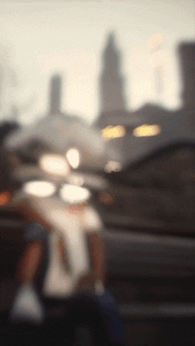 a blurry picture of a person standing in front of a city