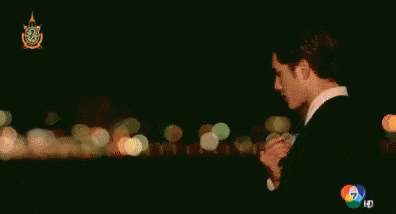 a man in a suit is standing in front of a blurry background with the word hd on the bottom right