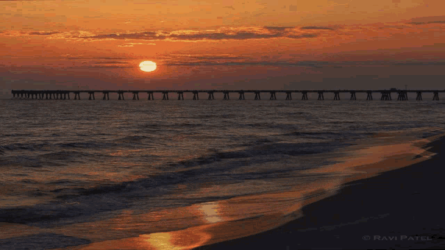 a picture of a sunset on a beach with the name ravi patel on the bottom