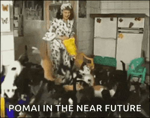 a woman in a dalmatian outfit is feeding a bunch of dogs in a kitchen