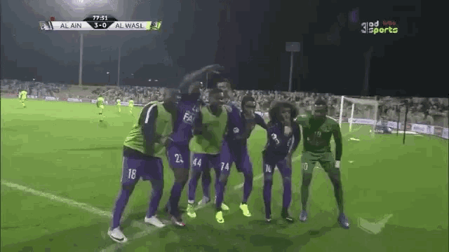 a group of soccer players are posing for a picture on a field with a score of 3-0