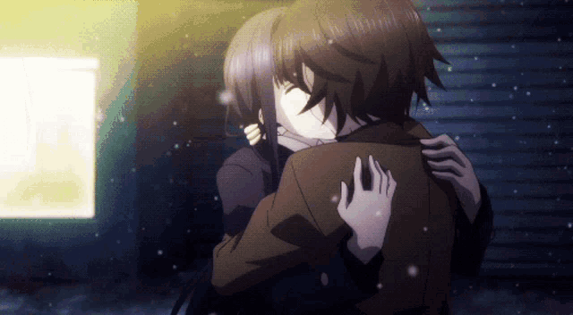 a man and a woman hugging each other in the snow