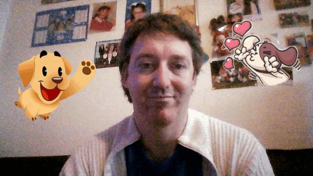 a man is sitting in front of a wall with pictures and a cartoon dog